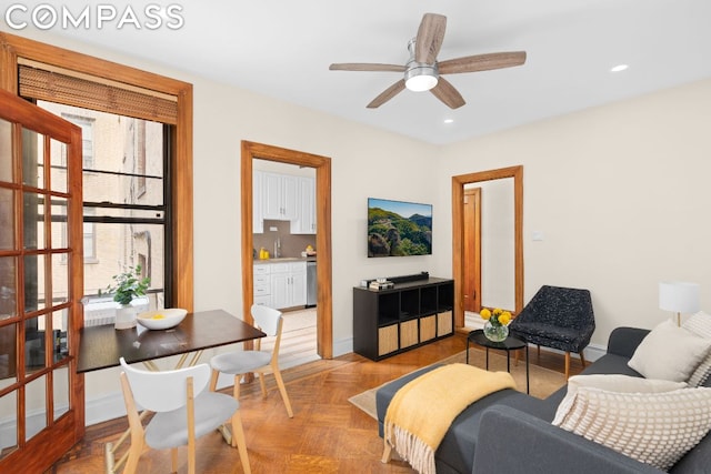 living room featuring ceiling fan and light parquet flooring