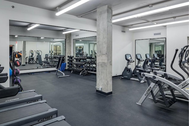 gym featuring ornate columns