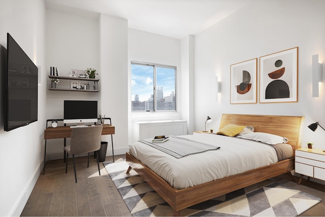 bedroom with wood finished floors and baseboards