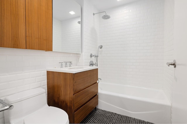 bathroom featuring bathtub / shower combination, toilet, vanity, tile walls, and decorative backsplash