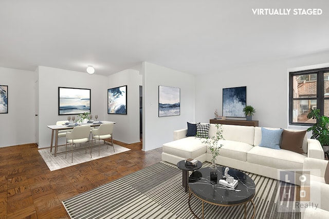 living room featuring dark parquet flooring