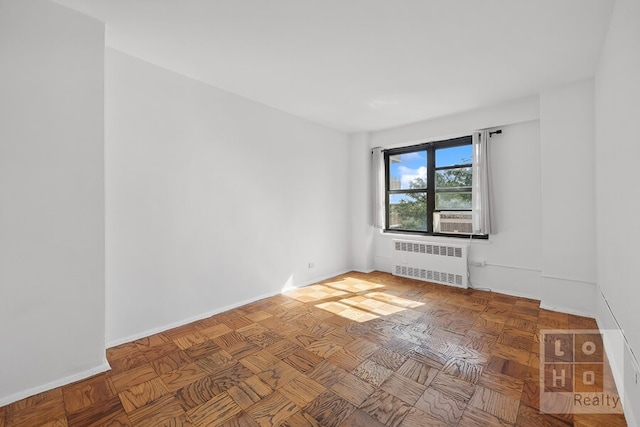 spare room featuring radiator heating unit and baseboards