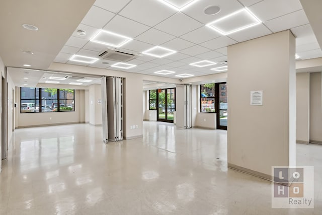 266 E Broadway Unit B606, New York City, NY 10002 - empty room featuring baseboards, a drop ceiling, and a smoke detector
