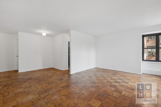 spare room featuring parquet floors