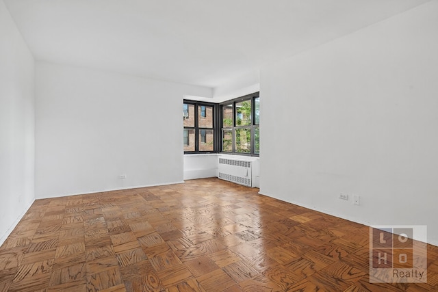 unfurnished room featuring radiator