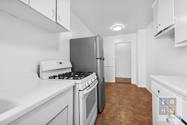 kitchen with light countertops, white cabinetry, white gas stove, and baseboards