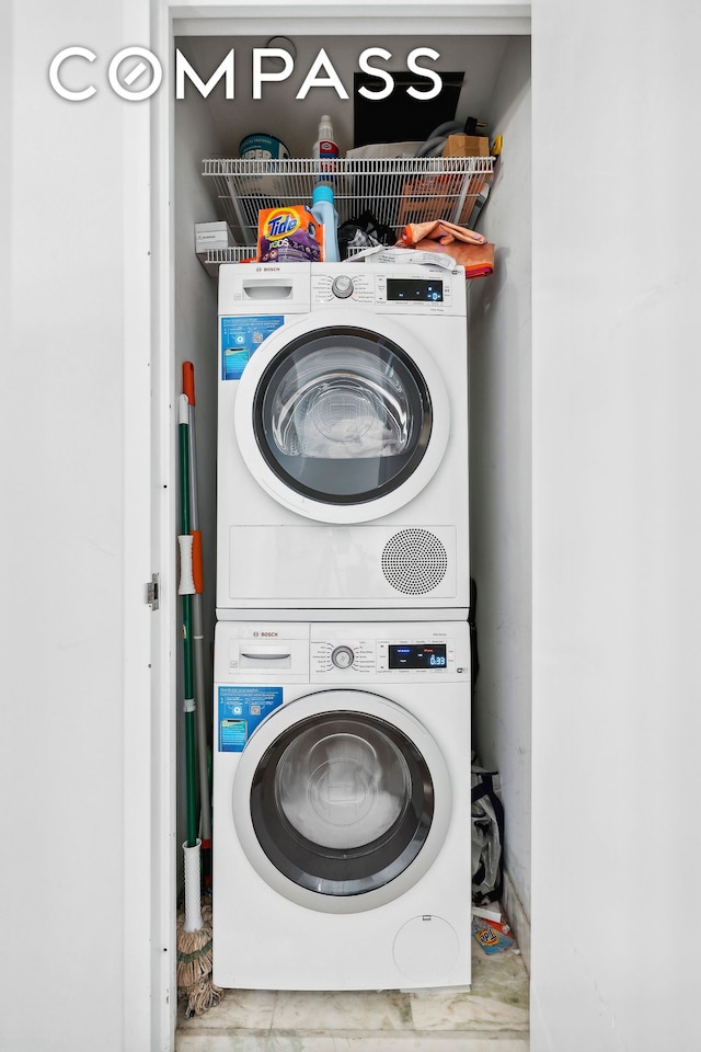 laundry area featuring stacked washer / dryer