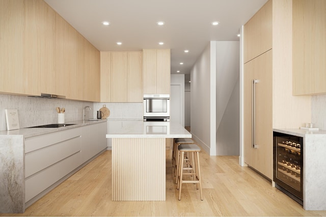 kitchen featuring decorative backsplash, light brown cabinetry, modern cabinets, wine cooler, and light wood-style flooring