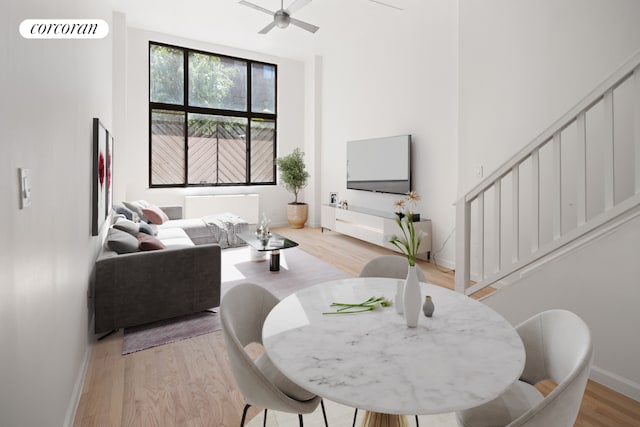 living room featuring light hardwood / wood-style flooring and ceiling fan