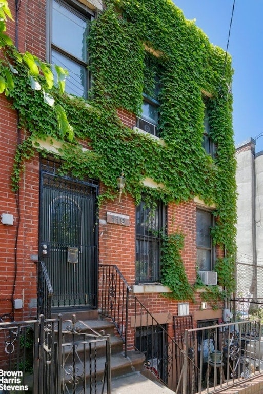 exterior space with brick siding and fence