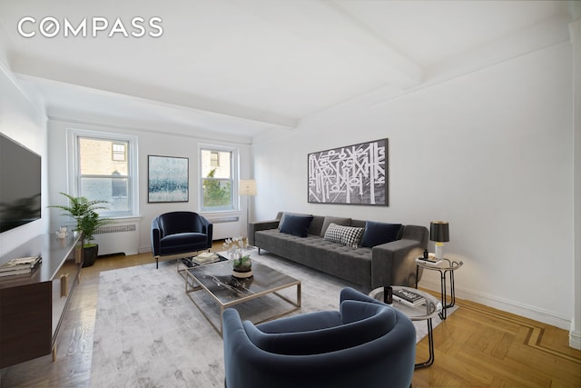 living room with beamed ceiling, baseboards, and radiator heating unit