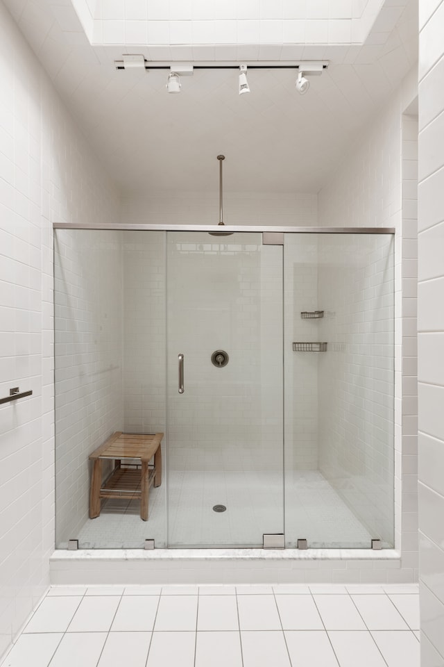 bathroom featuring tile patterned flooring and a stall shower