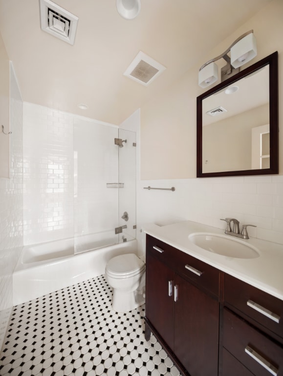 full bathroom with shower / bathtub combination, vanity, and toilet