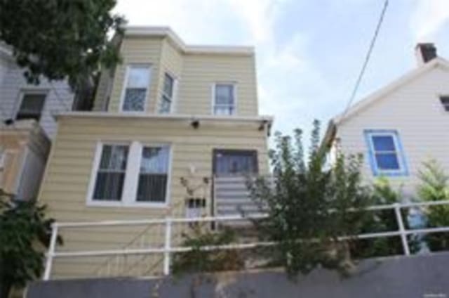 view of front of property featuring fence