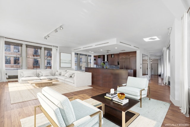 living room featuring light hardwood / wood-style floors and rail lighting