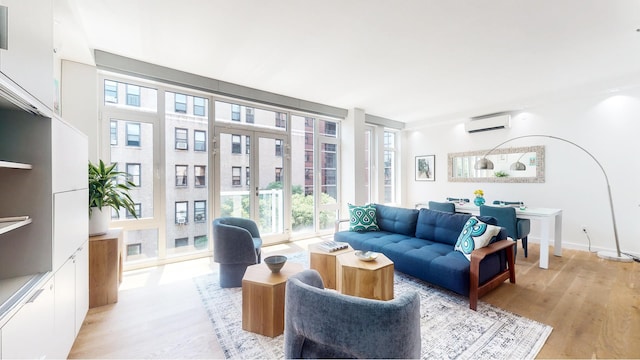 living room featuring visible vents, a wall mounted AC, and light wood-type flooring