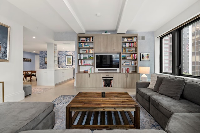 living area featuring beam ceiling, finished concrete flooring, recessed lighting, visible vents, and baseboards