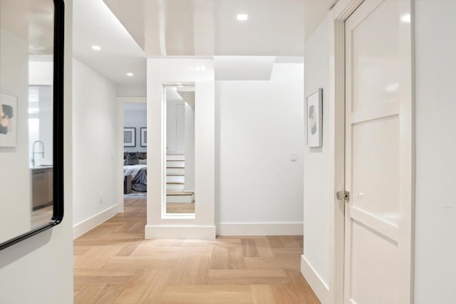 corridor featuring sink and light parquet flooring