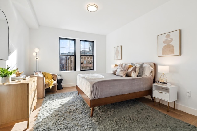 bedroom featuring light wood-type flooring and baseboards