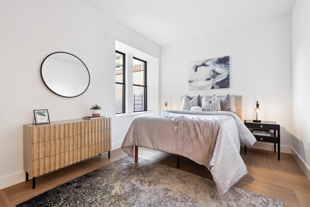 bedroom with wood finished floors and baseboards