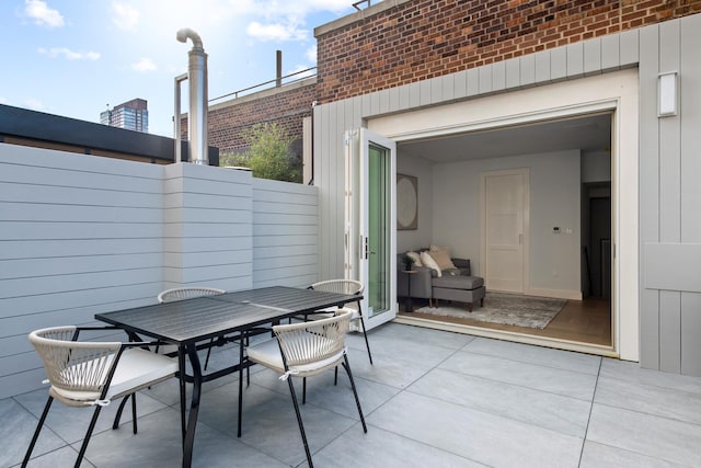 view of patio / terrace with outdoor dining area and fence