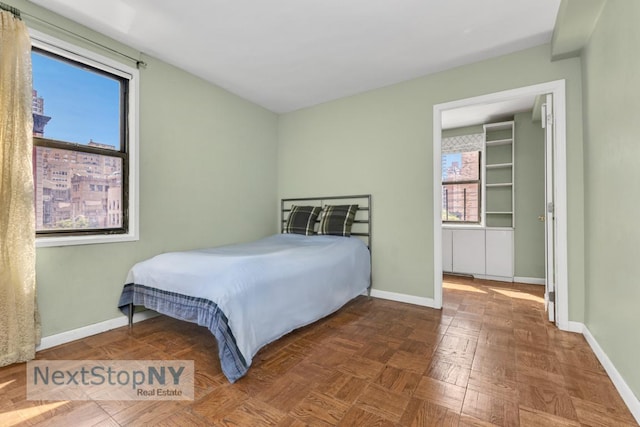 bedroom featuring dark parquet flooring