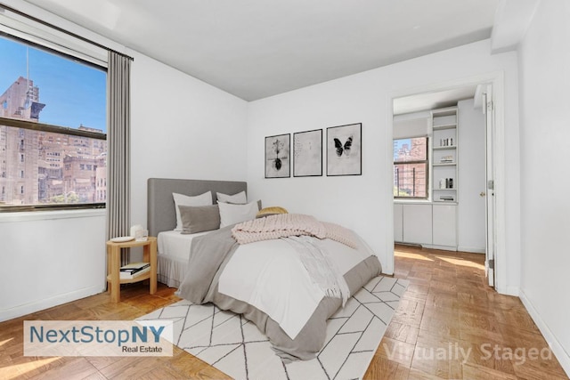 bedroom featuring light parquet flooring