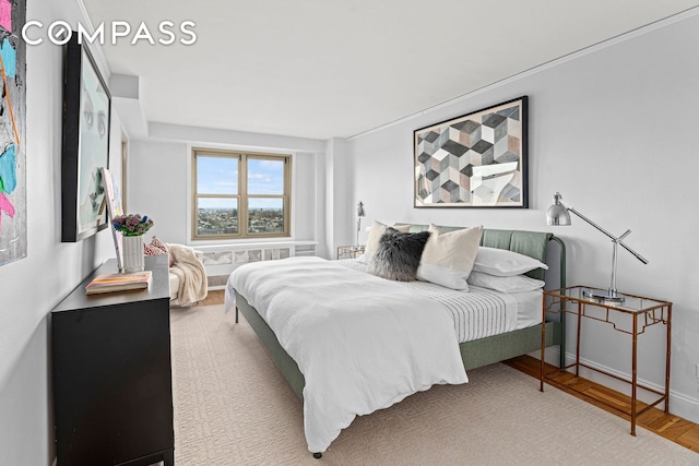 bedroom featuring baseboards and wood finished floors