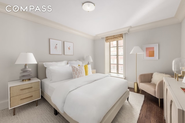 bedroom with dark wood-style floors, ornamental molding, and baseboards