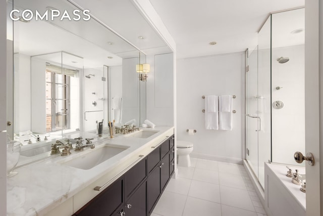 full bath featuring double vanity, a stall shower, a sink, and tile patterned floors