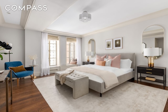 bedroom with crown molding and wood finished floors