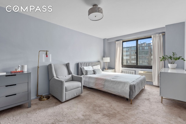 bedroom featuring light carpet and a view of city