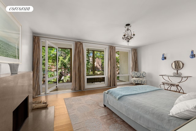 bedroom with visible vents, an inviting chandelier, and wood finished floors