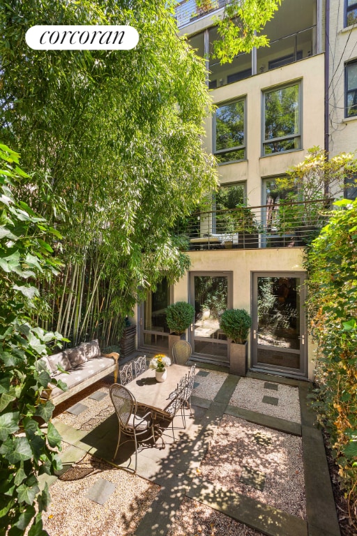 exterior space featuring outdoor dining space, a patio area, and stucco siding