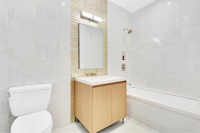 215 E 19th St Unit 7H, New York City, NY 10003 - bathroom featuring tile walls, vanity, and tiled shower / bath