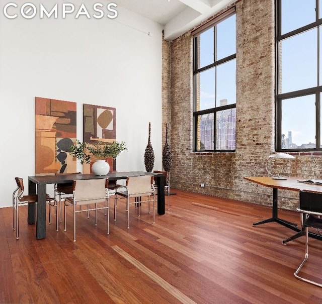 misc room featuring hardwood / wood-style flooring and a high ceiling