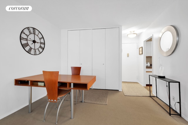 dining area featuring light carpet