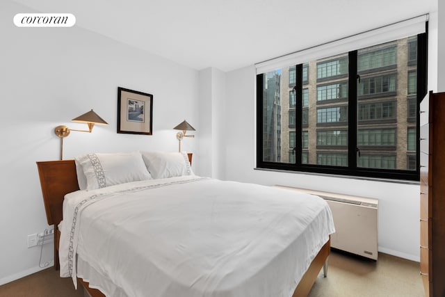 bedroom featuring radiator heating unit, carpet flooring, baseboards, and visible vents