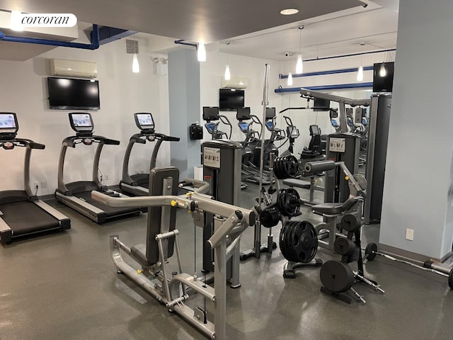 exercise room featuring an AC wall unit, visible vents, and baseboards