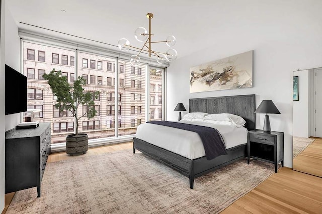 bedroom featuring hardwood / wood-style floors and a notable chandelier