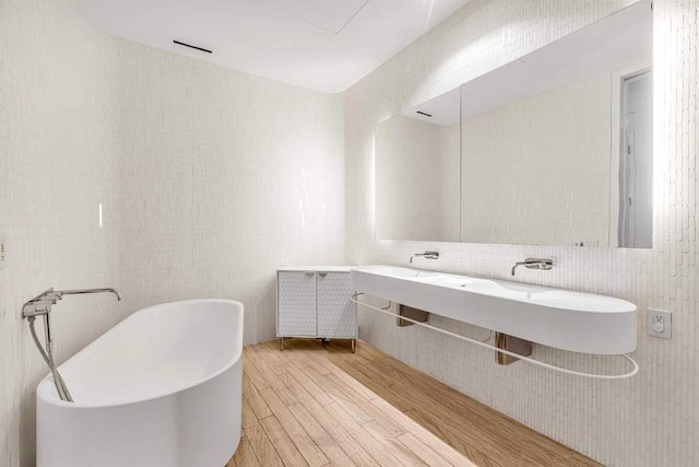 bathroom with vanity and a tub to relax in