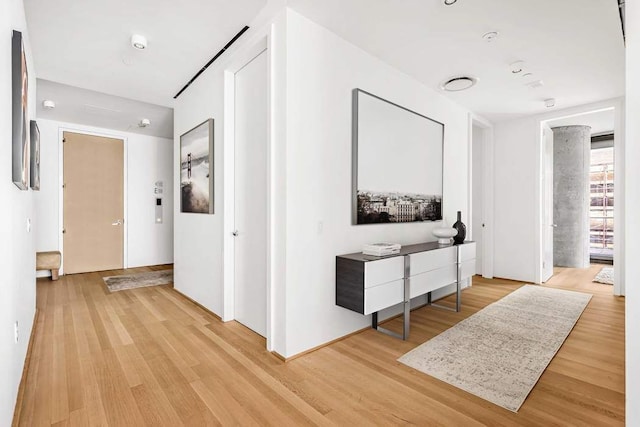 hall with light hardwood / wood-style floors