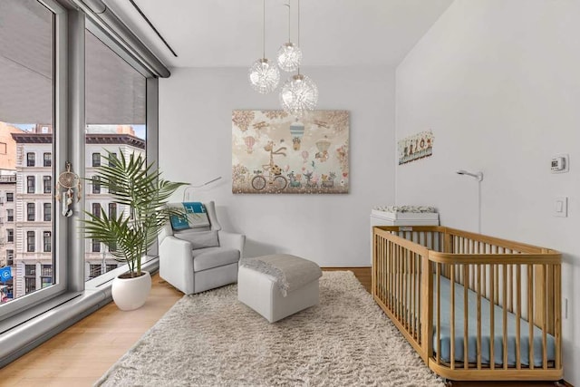 sitting room featuring hardwood / wood-style flooring and a notable chandelier