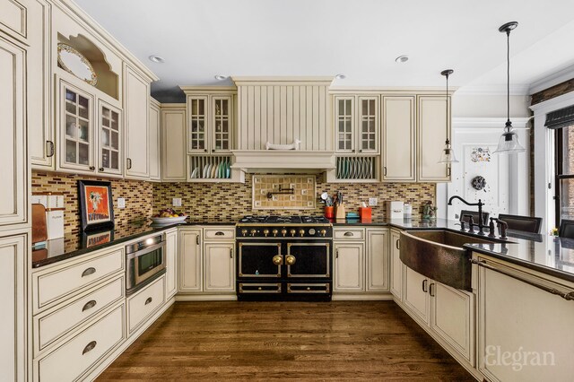 kitchen with cream cabinets, decorative light fixtures, and decorative backsplash