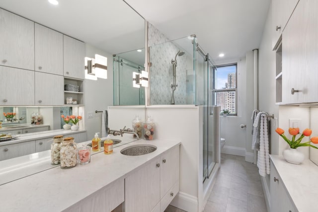 bathroom with recessed lighting, toilet, a shower stall, vanity, and baseboards