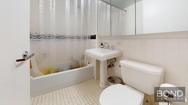 bathroom featuring toilet, tile walls, shower / tub combo with curtain, and tile patterned flooring