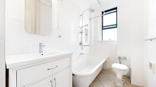 full bathroom with vanity, tile walls, tile patterned floors, and toilet