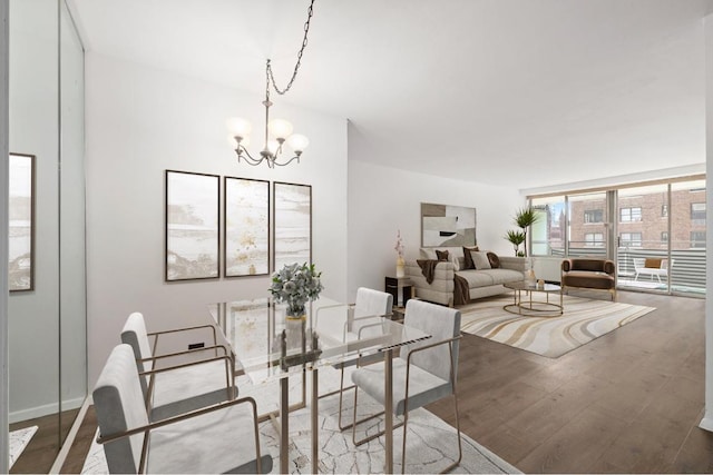 dining room featuring expansive windows, dark hardwood / wood-style floors, and a chandelier