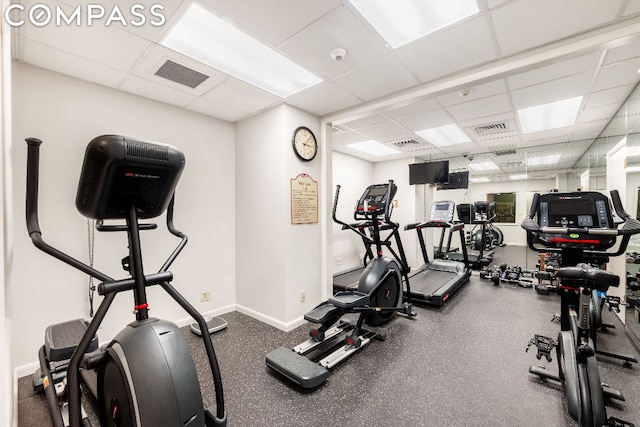 gym with a paneled ceiling