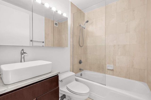 bathroom with bathtub / shower combination, visible vents, vanity, and toilet